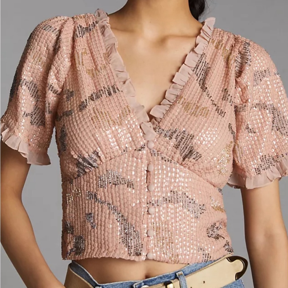Delicate ruffles and sequined details, this top brings an ethereal beauty.